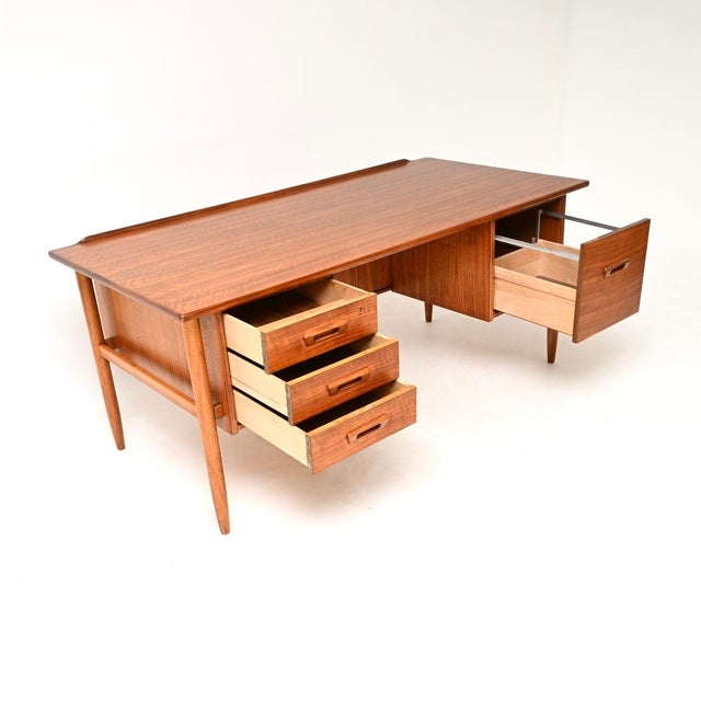 An absolutely stunning and extremely well made vintage Swedish walnut desk by Goran Strand for Lelangs Mobelfabrik. This...