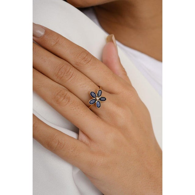 Pear Flower Shape Blue Sapphire and Diamond Ring in 18K Gold featuring natural blue sapphire of 1.65 carats and diamonds...