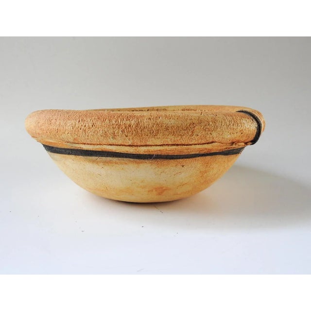 Pottery bowl by Mary Fischer well know Texas ceramic artist. Green glazed interior over imprint of leaf. Signed on bottom.