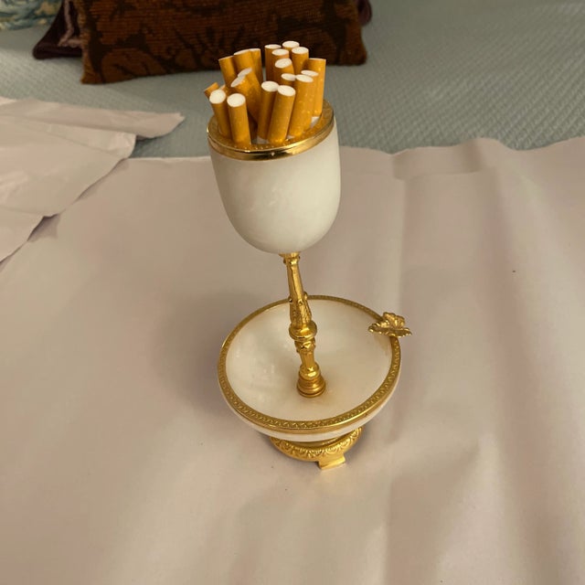 Mid Century Hollywood regency brass and alabaster cigarette holder and ashtray. Fine classical details. Rest cigarette on...