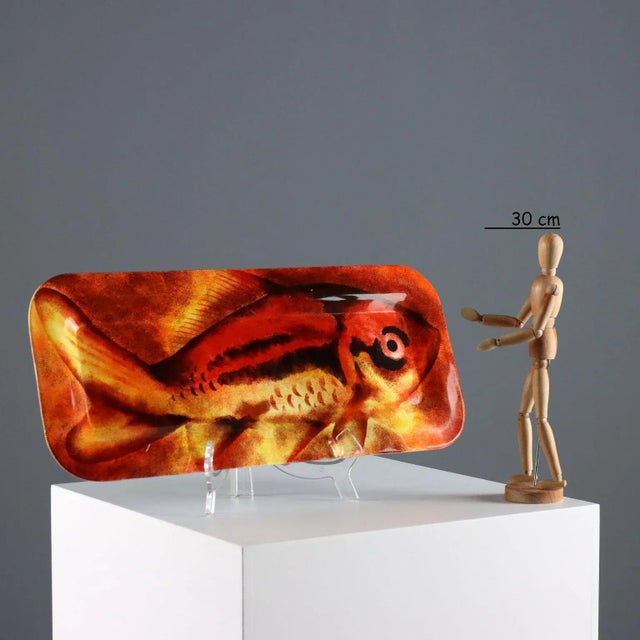 Rectangular aluminum tray with silkscreen decoration in shades of red and orange depicting fish. Manufacturer's label...