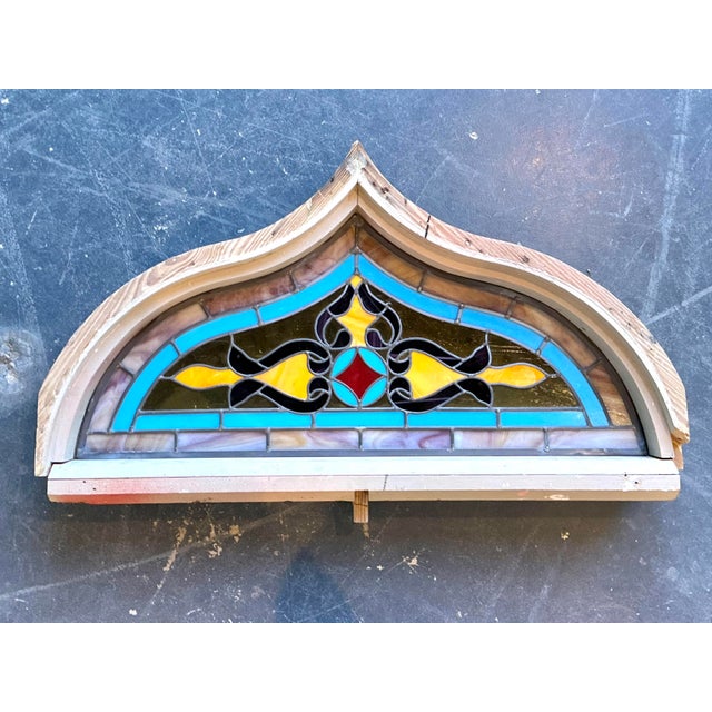 This striking vintage stained glass window captures the ornate spirit of Gothic Revival architecture through masterful...