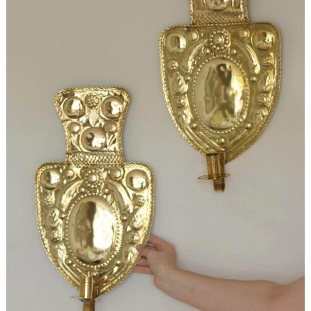 Made in Sweden Mid-century Swedish brass wall sconces, Meticulously handcrafted with embossed designs, the sconce...