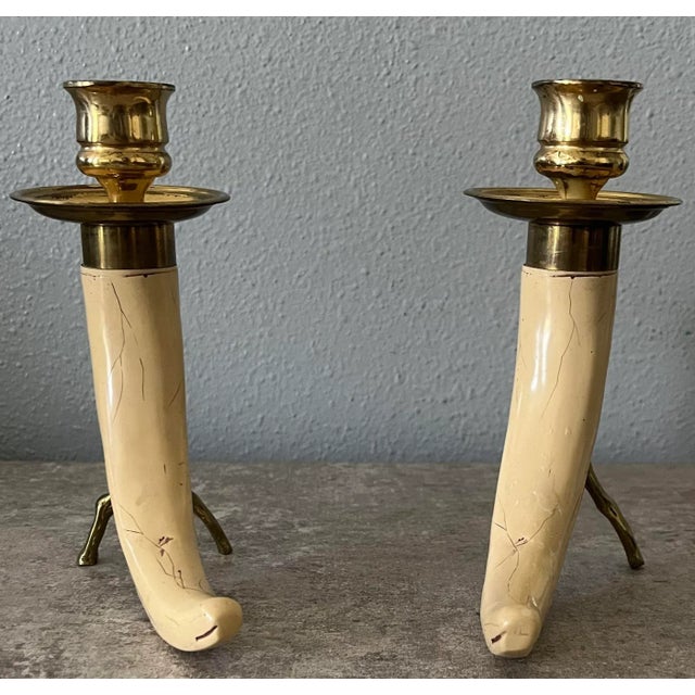 The most wonderful complement to any rustic or safari decor, these resin tusk and shaped brass stick detail candle holders...