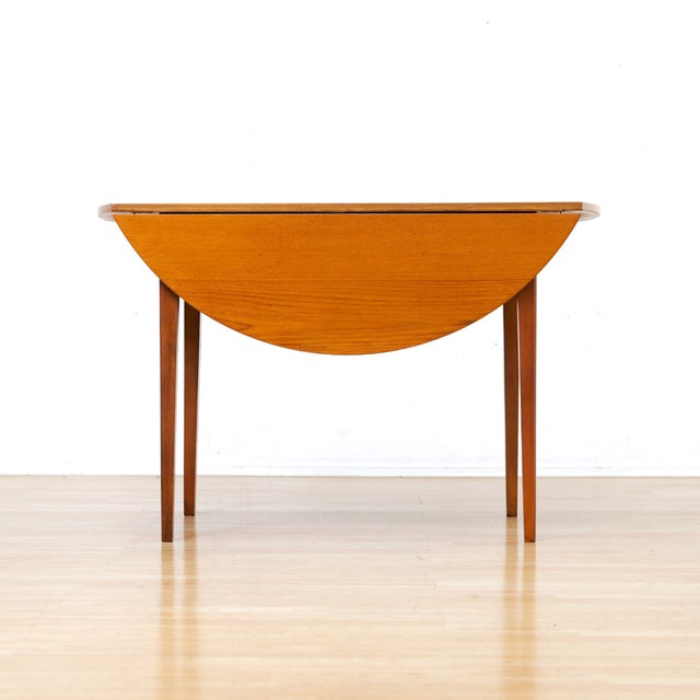 This vintage drop leaf dining table was produced in England during the 1960s. A wonderful Scandinavian inspired round teak...