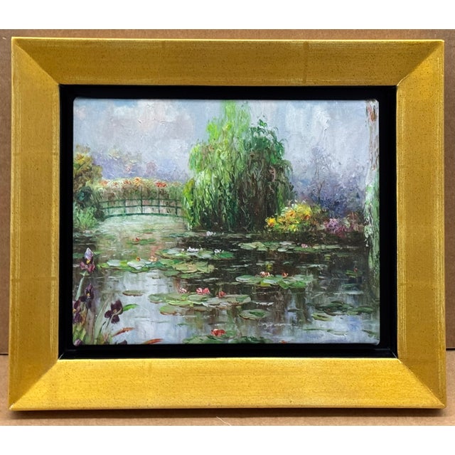 A lovely oil painting depicting Monet's garden with lily pond and Japanese bridge measures 14 x 2 x 12 inches in the frame...
