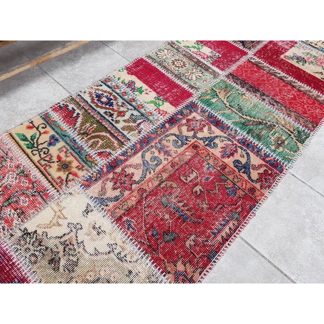 This is a vintage Turkish Oushak rug from the Mid 20th Century. The piece was hand-knotted.