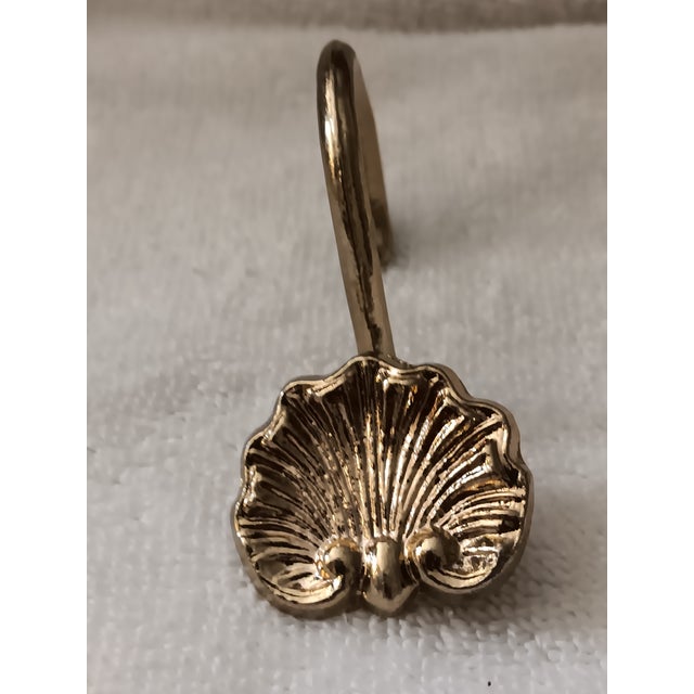 Gold colored brass shell shower curtain hooks, set of 10. From designer inventory, never used. Very lovely quality...