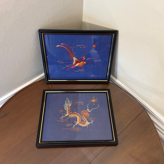 two framed silk embroidery of dragon and a phoenix The pair are depicted in vivid colors, and the artworks are likely...