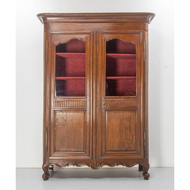 French armoire vitrine bookcase of the Louis 15 period. Glasse, ash & iron. The back and shelves of the wardrobe are...