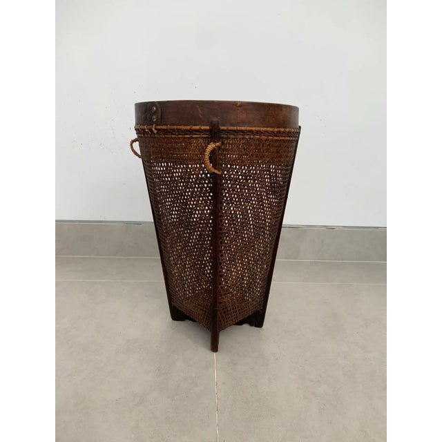 This mid-20th century hand-woven basket originates from the Dayak tribe of Borneo crafted with rattan fibres and an...