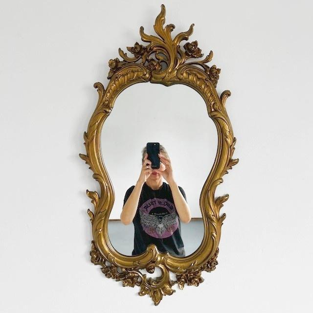 Vintage Baroque Syroco mirror in Hollywood Regency style from the 1960s with a gold resin frame. The mirror was made in...