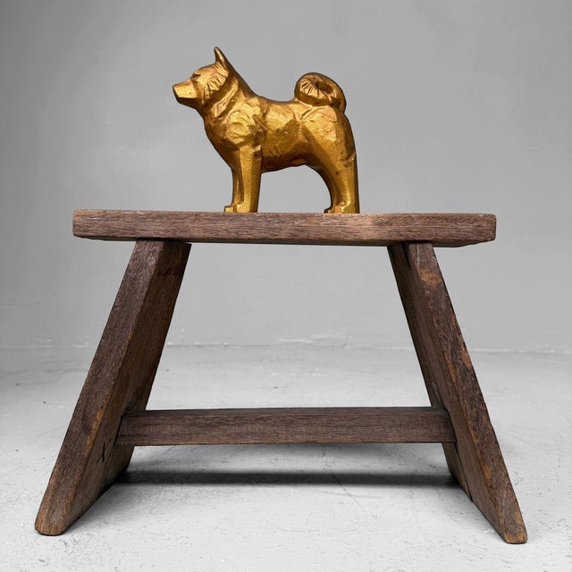 A compact yet powerful Japanese dog statue in solid metal, finished in a warm gold colour with a beautifully stylised...
