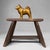 A compact yet powerful Japanese dog statue in solid metal, finished in a warm gold colour with a beautifully stylised...