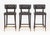 Set of Three Brabbu Chocolate Leather Bar Stools, with four ebonized wood legs conjoined by brass stretchers, label to...