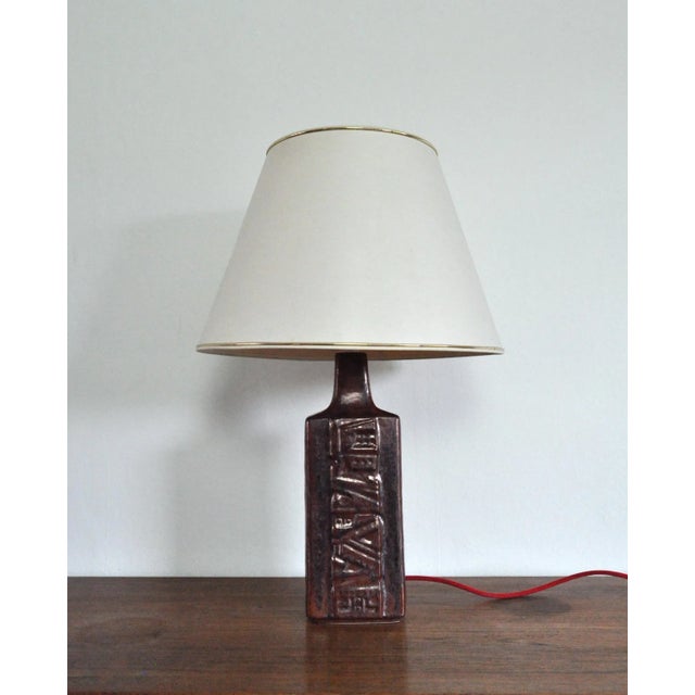 A table lamp designed and produced by désirée stentøj, denmark 1960s-70s. glaze features red, grey and black colors....