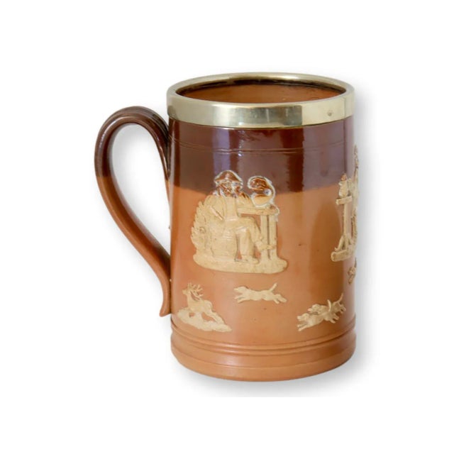 Doulton Lambeth stoneware smoking and ale set, comprised of an ale mug and a match striker. Renowned for its classic...