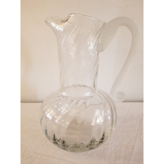 Beautiful, swirled crystal with a frosted rope handle. Perfect for a bedside table.