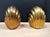 Solid brass scalloped bookends. Nice heavy construction with shiny brass. Felt on bottom. Circa 1970s. Each measures:...