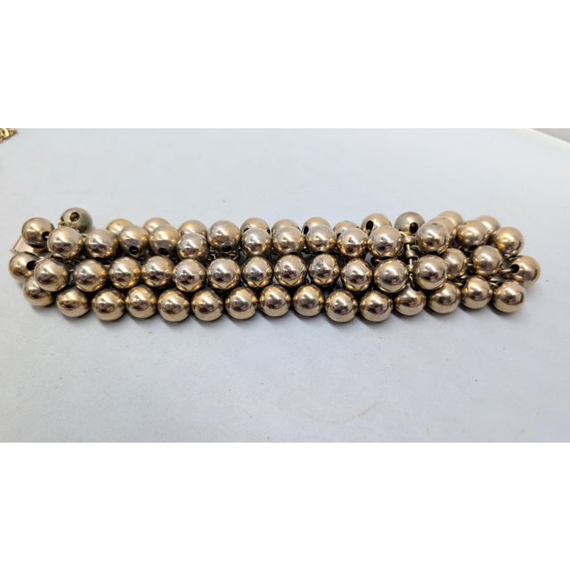 Mid 1960s goldtone machines balls on a mesh back charm bracelet with fold over clasp. Marked "NAPIER" on the back of the...