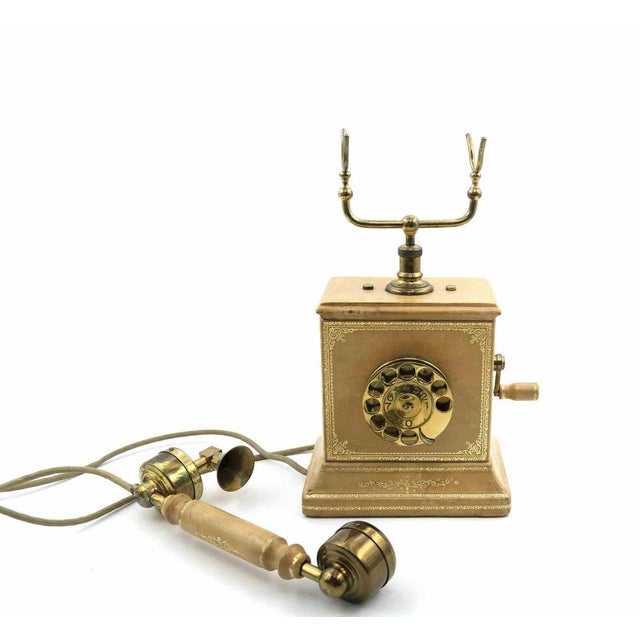 Vintage telephone is an original design object realized in the 1930s/40s. A brass and wood vintage telephone. Fair...