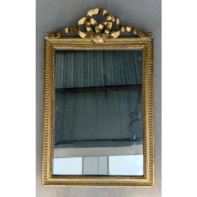 An exquisite 18th century French gilded marriage mirror, richly hand-carved in wood and finished in original water gilt....