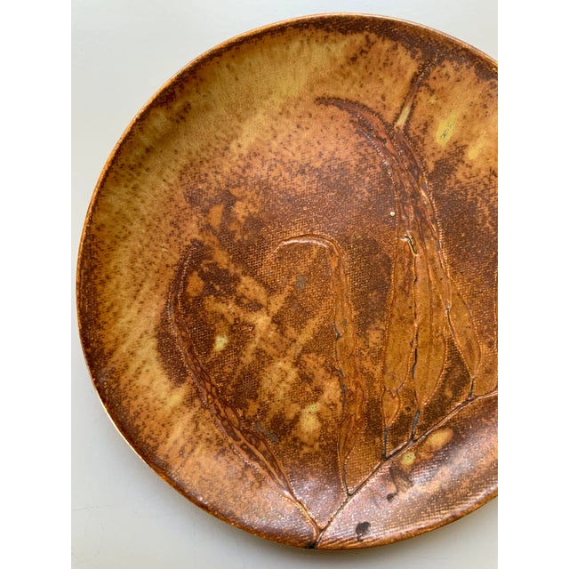 Artisan made studio pottery plate, with a beautifully rich and earthy design. Measures 8.5 inches diameter x .75 inches...