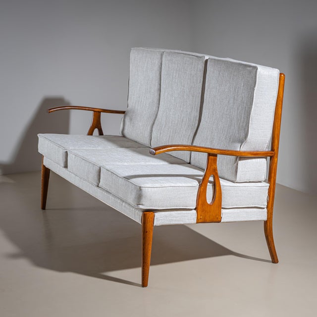 Set consisting of a three-seater sofa and two matching armchairs, featuring elegantly curved armrests and finely crafted...