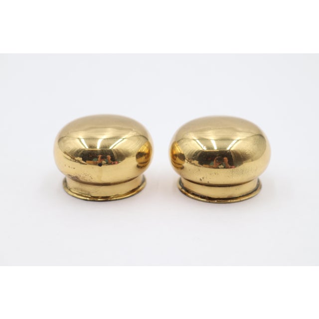 Reclaimed curtain rod end caps made of brass with a polished finish. Good condition with surface wear from prior use....
