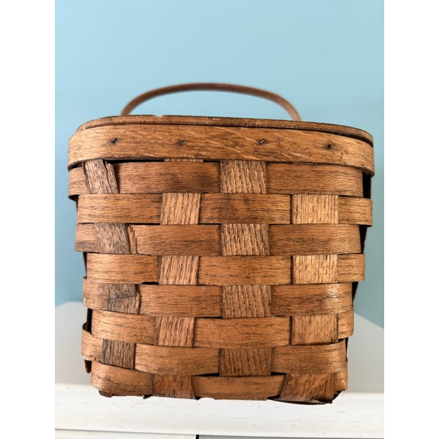 Vintage baskets have a way of bringing texture, warmth, and a sense of history to a space, and this charming picnic basket...