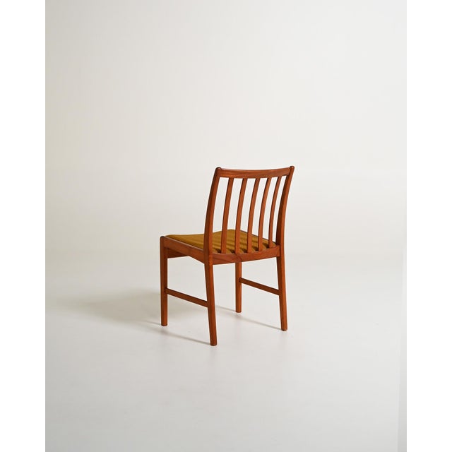 Set of 4 original vintage chairs from the 1960s. Featuring a teak wood frame and a lightly padded seat reupholstered in...