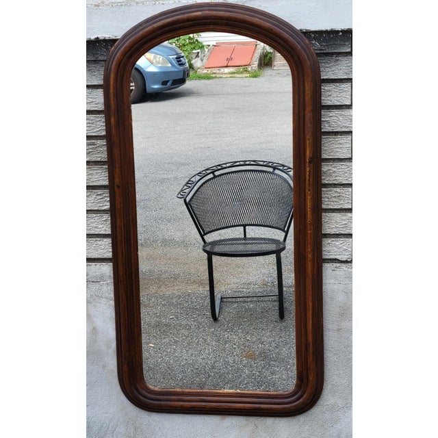 Beautiful 19th Century American Victorian walnut wall mirror featuring a classic arched-top frame with a rich natural...