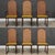 A set of six mid century modern solid walnut dining chairs with cane rounded backs designed by Milo Baughman for...