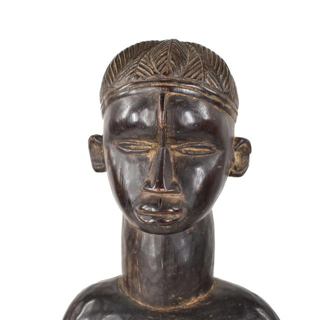 The Dan Standing Female Figure hails from Liberia and is a testament to the artistic brilliance of the Dan people. Carved...