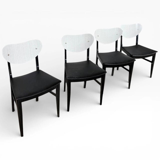 This set of mid-century dining chairs offers a perfect blend of vintage style and everyday comfort for your kitchen or...