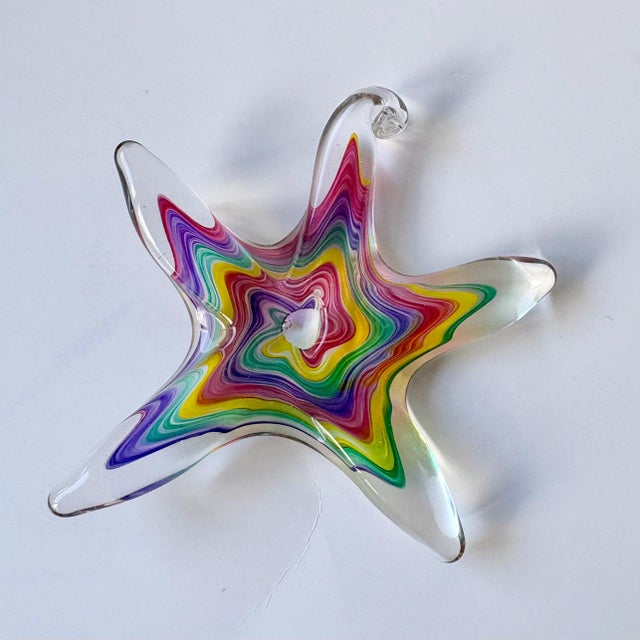 A vibrant signed handblown art glass starfish by acclaimed glass artist Luke Adams. This piece showcases layered, swirling...