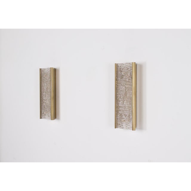 Pair of italian wall sconces in gilded metal with murano glass shades, dating from the 1960s/1970s. preserved in excellent...