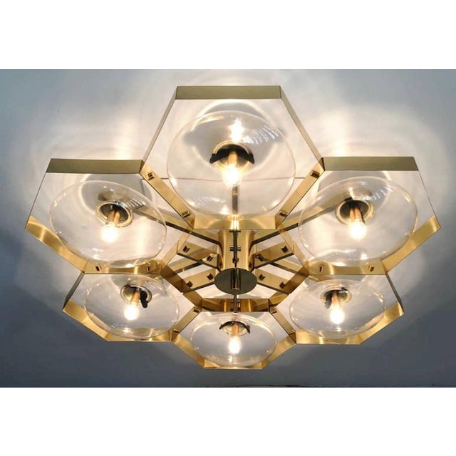 Italian midcentury flush mount with six clear Murano glass shades mounted on solid brass frame in lacquered polished brass...