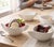 This set of four premium white porcelain vessels exemplifies the late-postmodern evolution of European ceramic design....