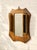 A wonderfully unusual antique grooming mirror featuring a warm wood frame and two original hanging clothes or grooming...