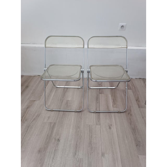 Magnificent and iconic pair of folding chairs by Giancarlo Piretti for Anonima Castelli. Italy, 1967. Chrome-plated steel...