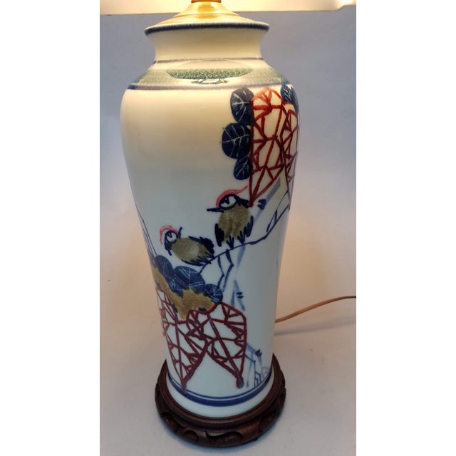 Hand painted Japanese porcelain features delicately painted birds with leaves and foliage in a more modern, geometric...