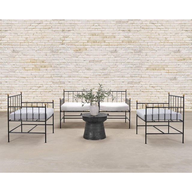 A whimsical set of four French mid-century modern architectural patio and garden lounge chairs crafted from iron and...