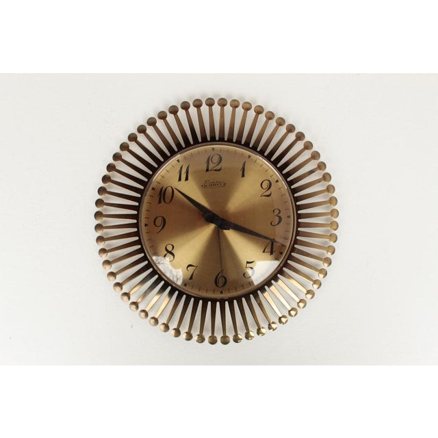 German mid-century brass wall clock with quartz movement. Manufactured in the 1960s. Very good condition, fully...