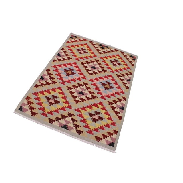 "Add a touch of elegance to your home with this casual chic hand woven Tribal Kilim wool rug. Constructed on a loom by...