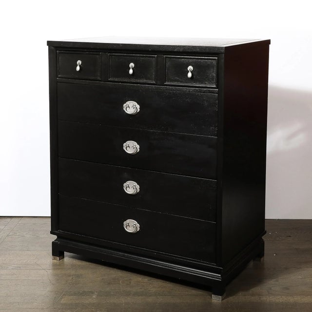 This substantial and reserved Mid-Century Modernist Chest of Drawers in Ebonized Walnut and Antique Nickel Hardware...