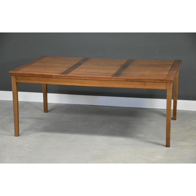 A mid century modern cherry draw leaf dining table with two leaves that extend from either end and self store by Ansager...