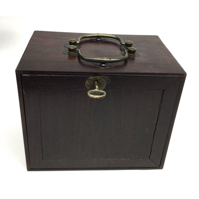 This little box, has lots of surprises. First we find the 2 brass handles on the top of the box, then we spot the key....