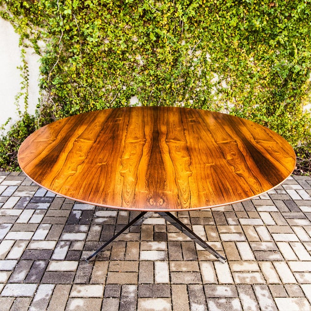 Expertly restored rosewood dining or conference table by Florence Knoll for Knoll International, produced in the United...