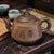 This Vintage Chinese Yixing Zisha Clay Tea Pot is a collectible piece originating from China, showcasing traditional...